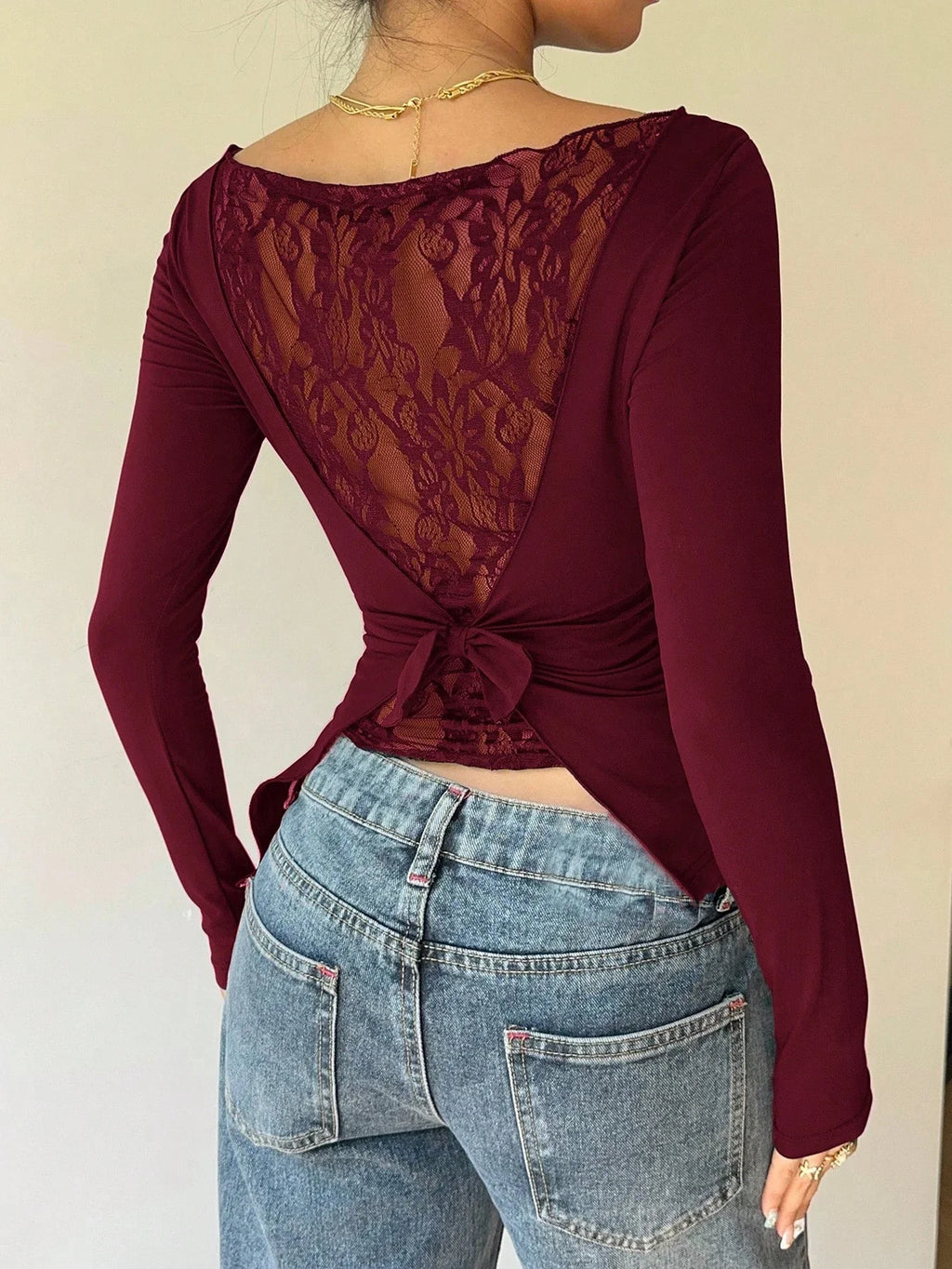 Long-Sleeve Lace Back Bow Top with Asymmetric Hem